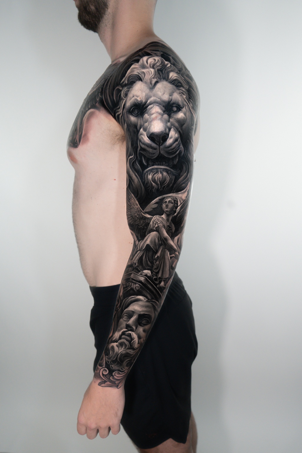 Black-and-gray lion and angel cover-up sleeve by Tony Vilella